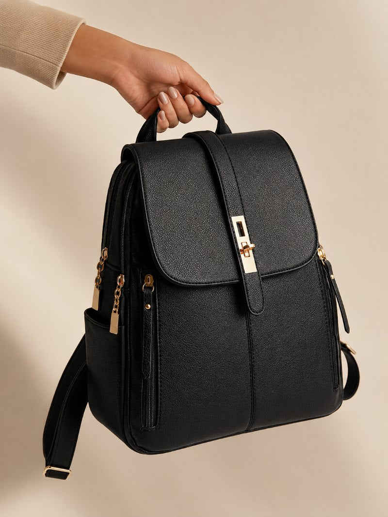 Black leather backpack held by the handle