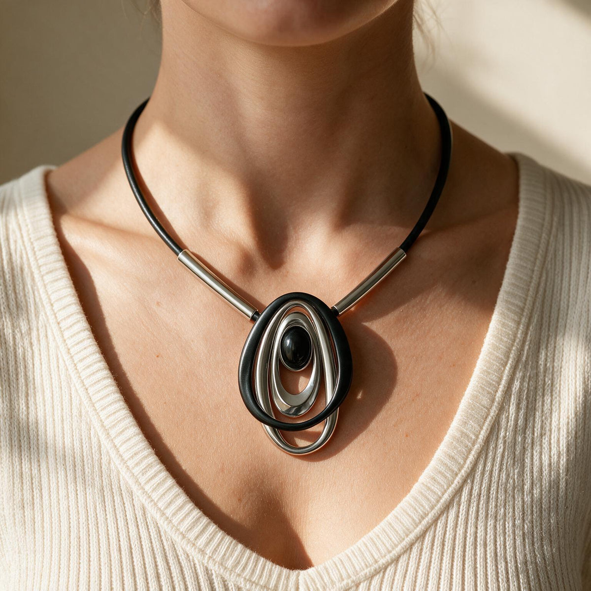 Edgewater Swirl necklace worn on a cream knit