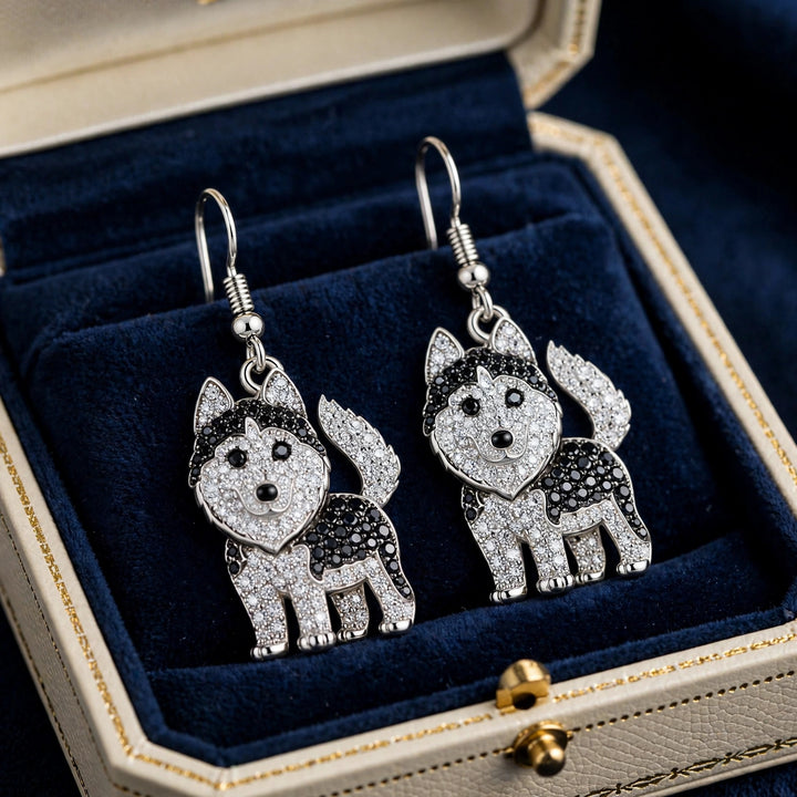 Pair of silver-tone husky earrings in clear and jet-black rhinestones, shown together at a three-quarter angle