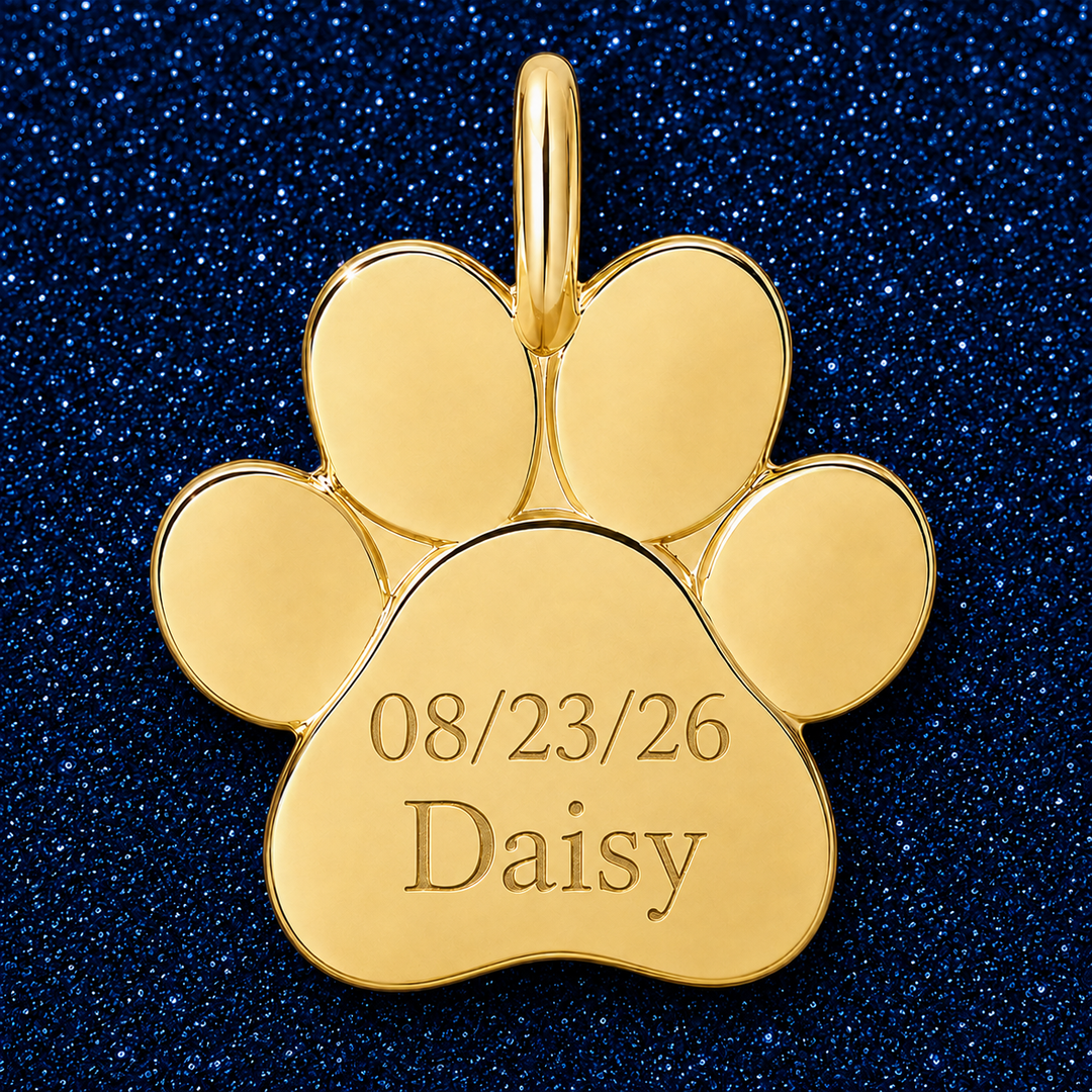 Gold paw charm engraved with a date and pet name