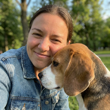 A selfie with a beagle, cheek to cheek, outdoors