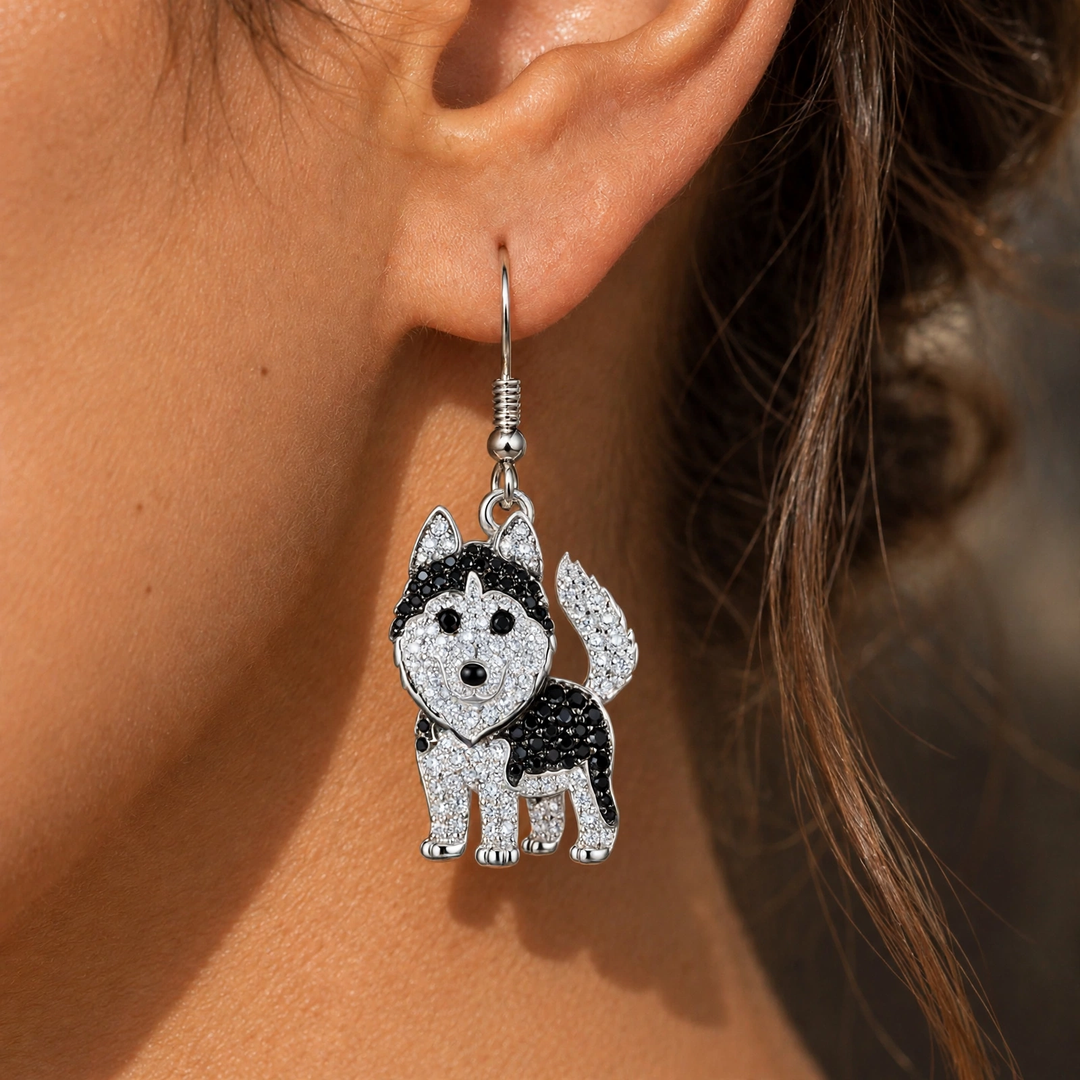 Rhinestone husky drop earring worn on the ear, hanging below the lobe from a silver-tone French hook
